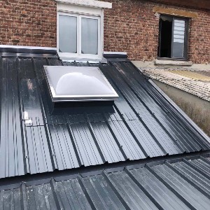 Pose d'une toiture en bac acier avec installation d'un puit de lumière